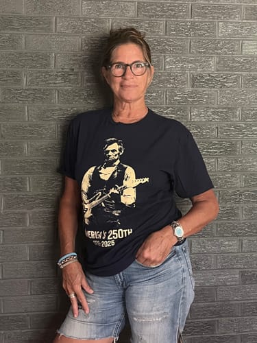 Reviewer wearing the dark Lincoln 250 T-Shirt featuring a graphic of Abraham Lincoln playing an electric guitar.