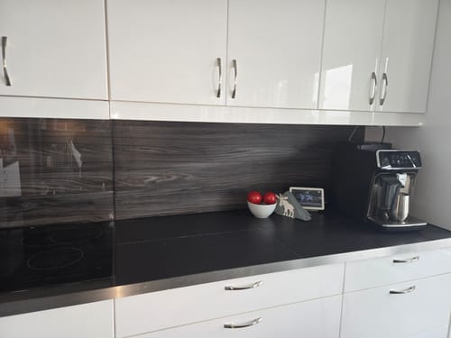 Anmelder viser den mørke Sangallo Lava kontaktplasten som en moderne bakplate med tre-look på kjøkkenet.