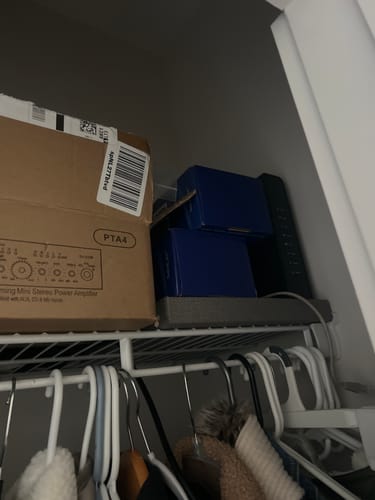 Customer's two blue boxes for the NovaCare Anti-Choking Device stored on a closet shelf.