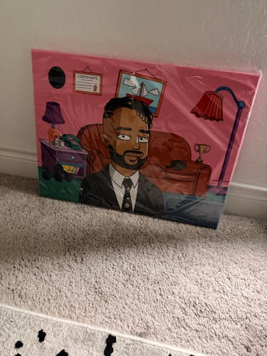 Customer's Horizontal Canvas with a custom cartoon portrait of a person in an office, still in its plastic wrapping.