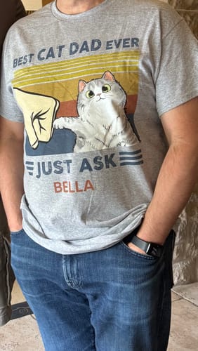 Customer wearing the personalized grey Best Cat Dad Ever t-shirt with the name 'Bella'.