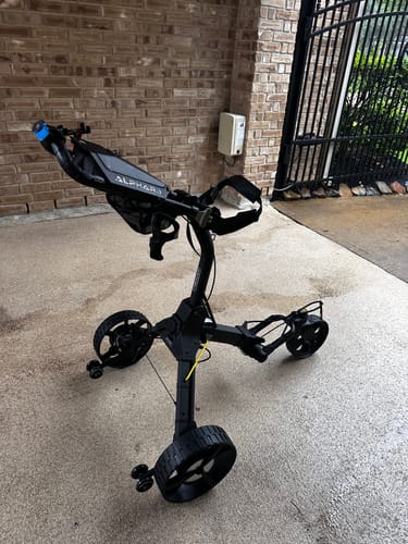 Customer's black Cybercart standing fully assembled on a patio, showcasing its stable design.