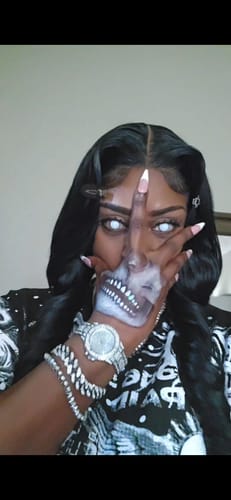Reviewer wearing Halloween White out Colored Contact Lenses, completing a spooky look with skull makeup on their hand.