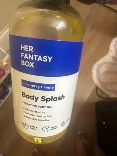 Close-up of the customer's bottle of Blueberry Créme Body Splash hydrating body oil.