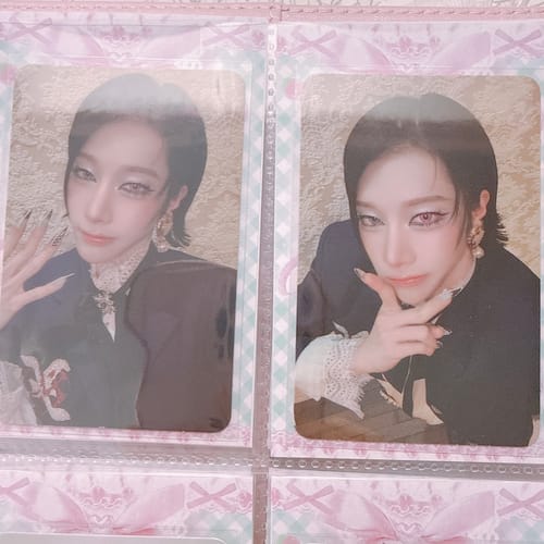 Customer's two XLOV "I,God" Official Photocards of a person with dark hair in a decorative binder sleeve.