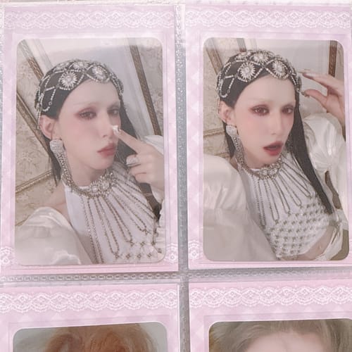 Customer's two XLOV 'I,God' official photocards showing a person with a jeweled headdress, held in a pink binder.