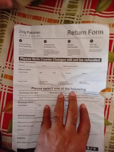 Reviewer holding a paper return form.