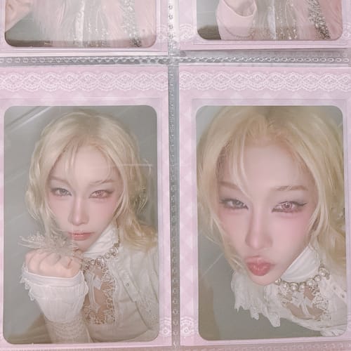 Customer's two XLOV 'I,God' official photocards showing a person with blonde hair in a decorative pink binder sleeve.