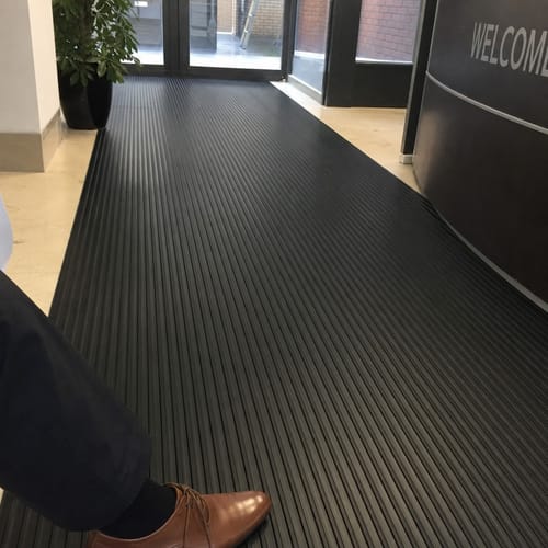 Reviewer's Heavy Duty Flat Ribbed Rubber Flooring installed in a professional office entrance corridor.