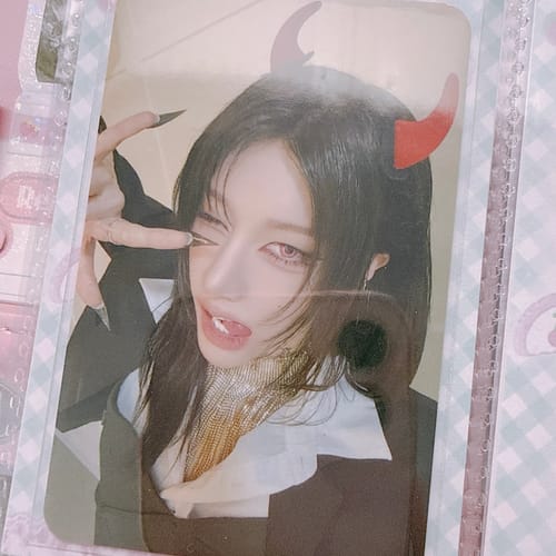 Customer's XLOV "I,God" photocard shows a person wearing red devil horns, winking, and sticking their tongue out.