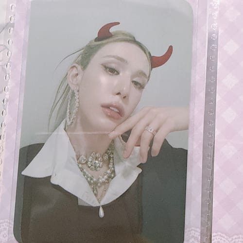 Customer's XLOV "I,God" photocard featuring a person wearing red devil horns and a collared shirt.