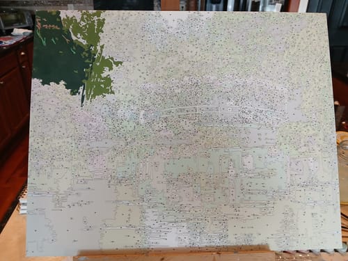 Customer's Custom Paint by Numbers Kit canvas in progress, with the top-left section painted in green tones.