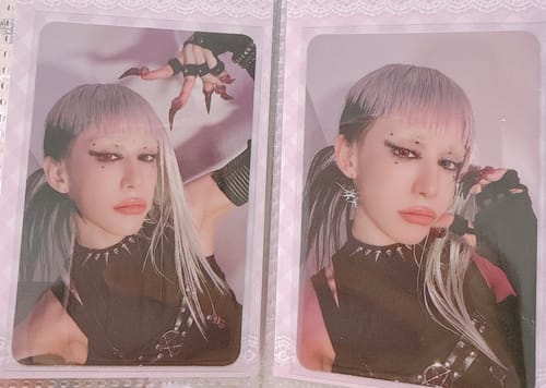 Customer's two XLOV "I,God" official photocards showing a person with purple hair and dramatic makeup.