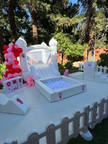 Customer's white Happy Station A soft play set with a ball pit and slide, arranged outdoors for a party.