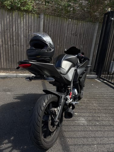 Reviewer's black Yamaha R125 motorcycle parked outdoors, showing its clean-looking rear.