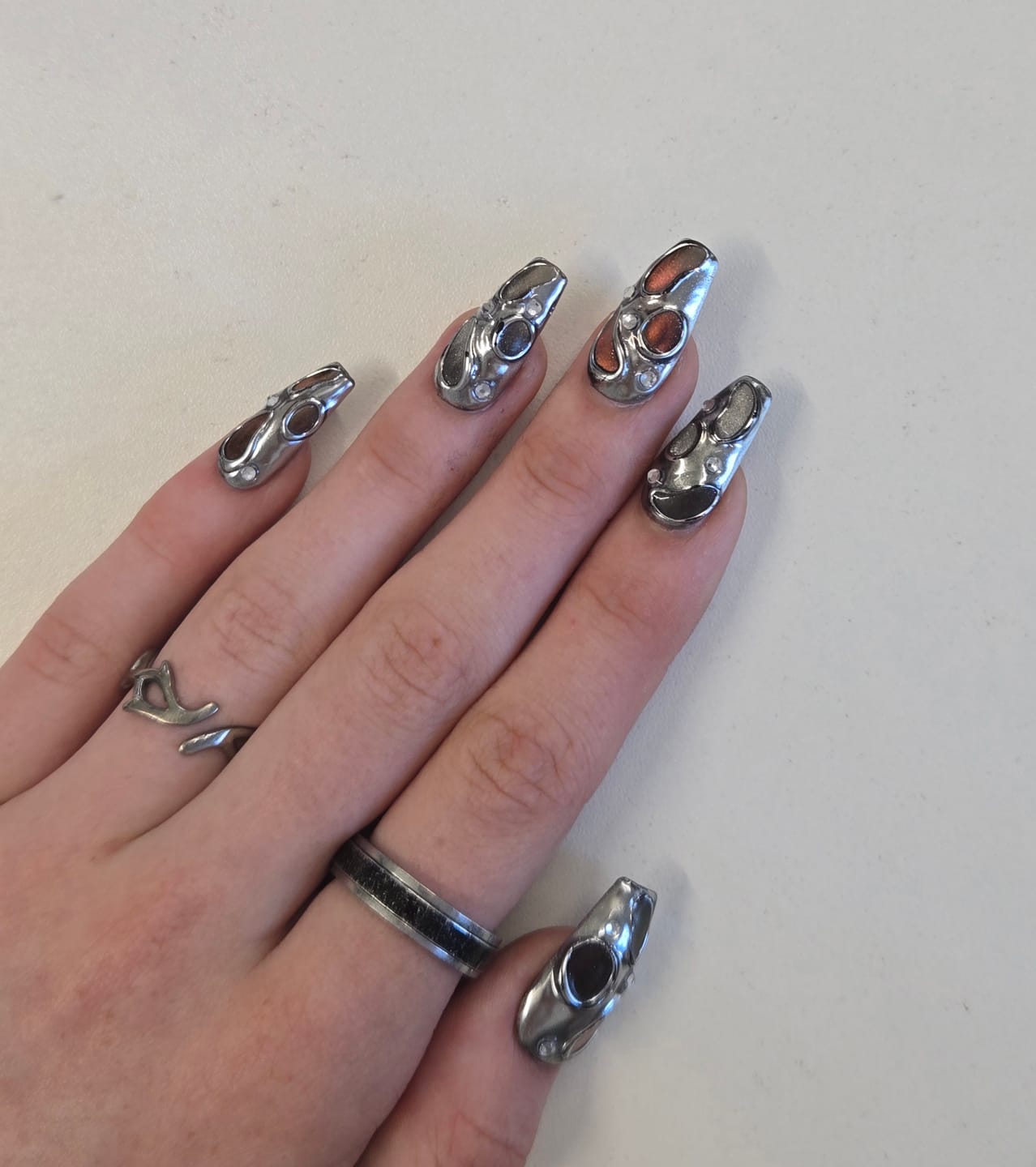 Customer photo review of Molten Chrome Blood Press-On Nails – Silver & Red Cat Eye Fake Nails