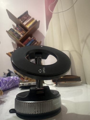 Customer's black MagPro Magnetic Phone Holder showing its sturdy suction base on a white desk.