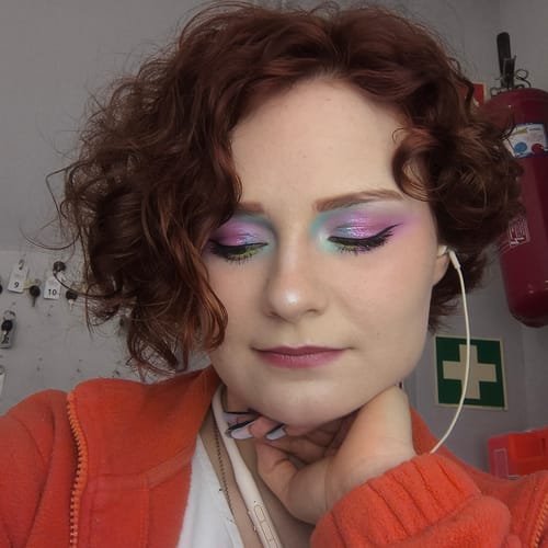 Reviewer wearing a vibrant, multi-color eye look using the Creative Comeback XXXL Eyeshadow Palette.