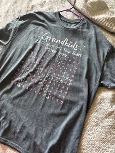 Customer's dark grey personalized shirt showing the word search puzzle design with names circled on the front.