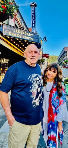 Customer wearing the blue Lincoln Flag T-Shirt with another person in front of the Egyptian Theatre.