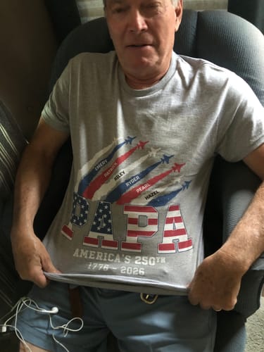 Customer wearing the grey personalized shirt with a patriotic 'PAPA' design for America's 250th anniversary.