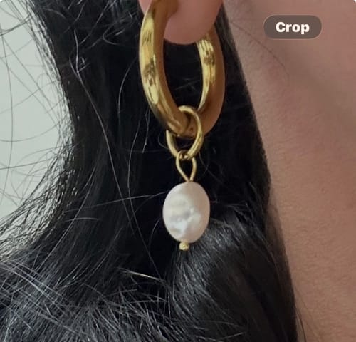 Customer's close-up of the Bethany Pearl Drop Hoop earring, showing the thick gold hoop with a dangling pearl.