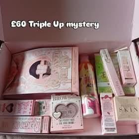 Reviewer's open Trippple Mystery Box showing the assortment of makeup and skincare products received inside.