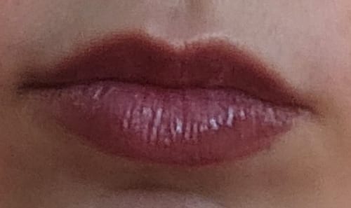 Close-up: Reviewer's lips showing the lasting color from the Peptide Lip Glaze after wearing off.