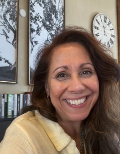 Reviewer smiling, showing glowing skin after using the Seranova Micro Infusion System.
