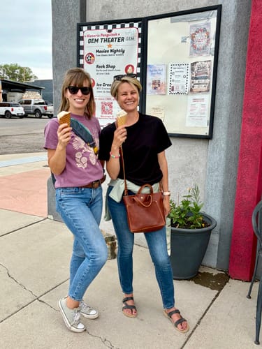 Reviewer wearing the purple Pine Pal T-Shirt and jeans, showing its relaxed fit outdoors.