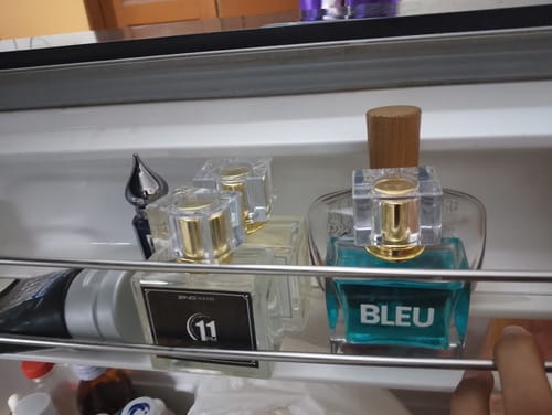 Customer's 'Bleu De Zing' and '11 PM' perfume bottles from the Summer Box set arranged on a shelf.