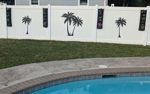 Customer's Tropical Palm Trees wall decals applied to a white outdoor fence next to a swimming pool.