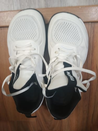Reviewer's overhead view of the white CUURT Muuv court shoes, highlighting the wide toe box.