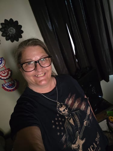 Reviewer smiling while wearing the black American Rock 250 T-Shirt, showing the Lincoln graphic.
