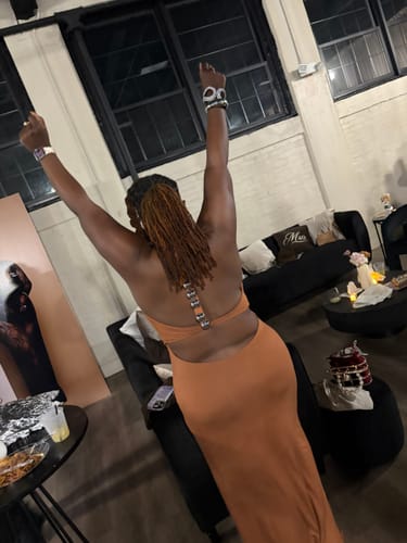 Reviewer showing the open back and silver dome detail of the Modal Open Back Dome Maxi Dress.