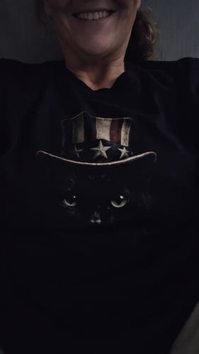 Partial view of a customer smiling while wearing the black Uncle Sam Cat t-shirt.
