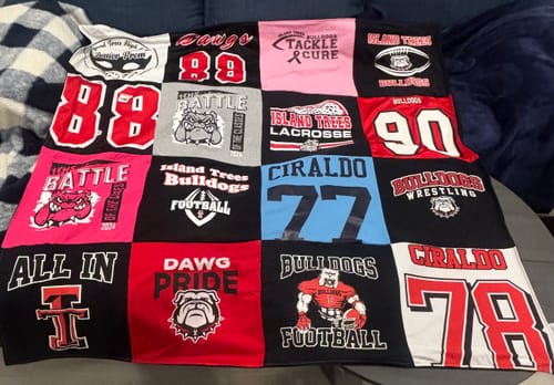 Customer's finished Project Repat T-Shirt Quilt made from various colorful sports t-shirts and jerseys.