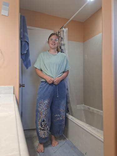 Reviewer (5'10") in a try-on photo wearing the retro embroidery wide-leg jeans.