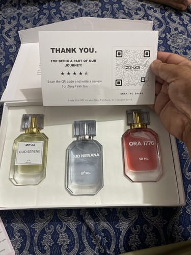 Customer showing the OUD Supreme BUNDLE in its open box with the three included Oud Serene, Nirvana, and Ora 1776 fragrances.