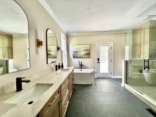Customer's Sunlit Waters Canvas Art hanging in a newly renovated bathroom above a freestanding tub.