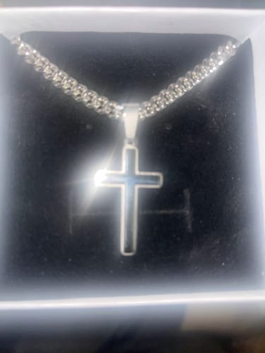 Customer's Artisan Cross on a Cuban link chain with a dark inlay, displayed in its black gift box.