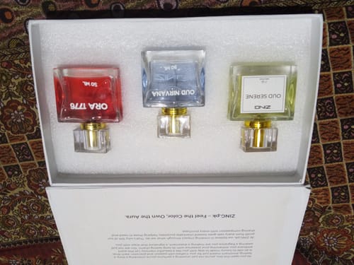 Customer's OUD Supreme BUNDLE showing the three fragrance bottles, Ora 1776, Oud Nirvana, and Oud Serene, in their open white box.