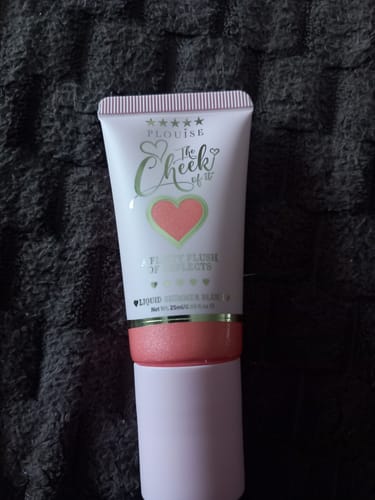 Customer's white tube of The Cheek Of It Shimmer Liquid Blush, showing the pink sponge-tip applicator.