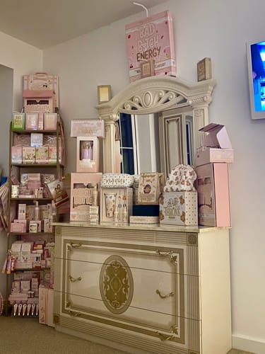 Customer's large collection of pink What A Treat! products displayed on a dresser and shelving unit.