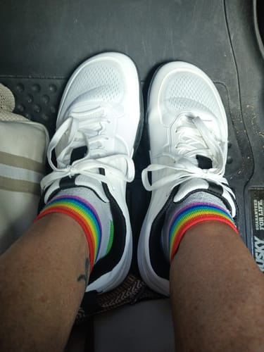 A reviewer's feet in white CUURT Muuv court shoes with a wide toe box, seen from above.