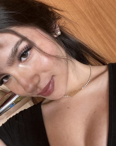 Reviewer wearing the sparkly Signature Name Tennis Necklace in a close-up photo.