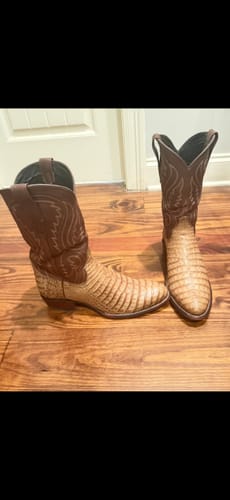 Customer's handsome Dillon II Western Boots in toffee caiman, standing on a wooden floor.
