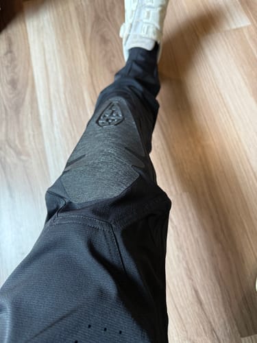 Customer's first-person view of the black Coffindodger DC Park Pant, highlighting the reinforced knee panel and slim, tapered leg.