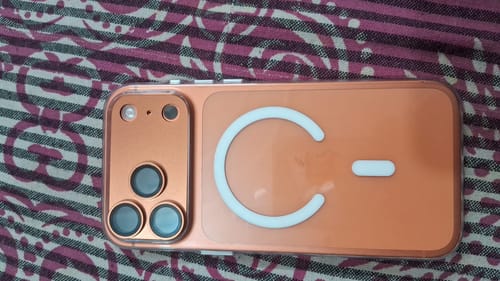Customer's Anti-Yellow Magsafe Clear Case on an orange phone, showing the magnetic ring and camera protection.