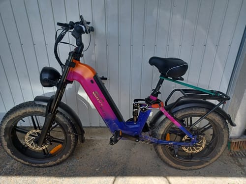 Customer's CMACEWHEEL V20 fat bike with a unique pink and blue paint job, shown with muddy tires after a ride.